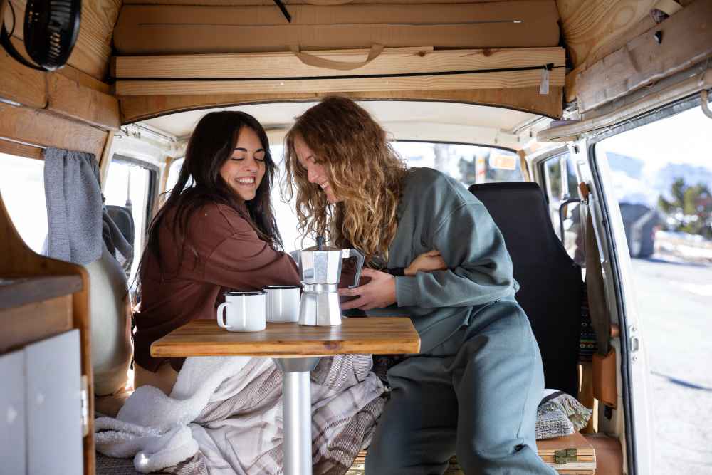 Two friends enjoying coffee together in a winter setting